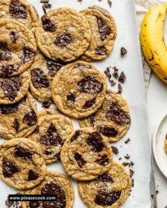 Banana bread chocolate chip cookies stacked on a plate, freshly baked and delicious.