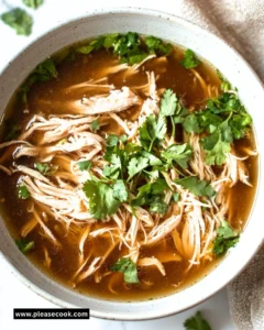 Delicious bowl of crockpot Chicken Pho topped with fresh herbs and lime