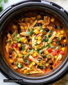 Delicious Crockpot Fiesta Chicken with vibrant ingredients in a slow cooker.