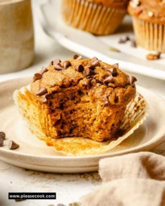 Healthy pumpkin muffins on a wooden table with autumn decor