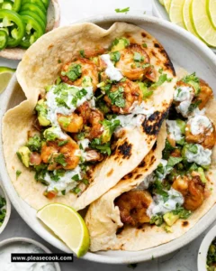 Delicious shrimp tacos topped with fresh avocado salsa.