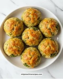 Delicious baked broccoli cheese balls served on a plate with a dip