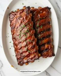 Delicious BBQ Baby Back Ribs grilled to perfection with a smoky glaze.