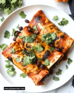 Delicious Black Bean and Butternut Squash Enchiladas garnished with fresh herbs