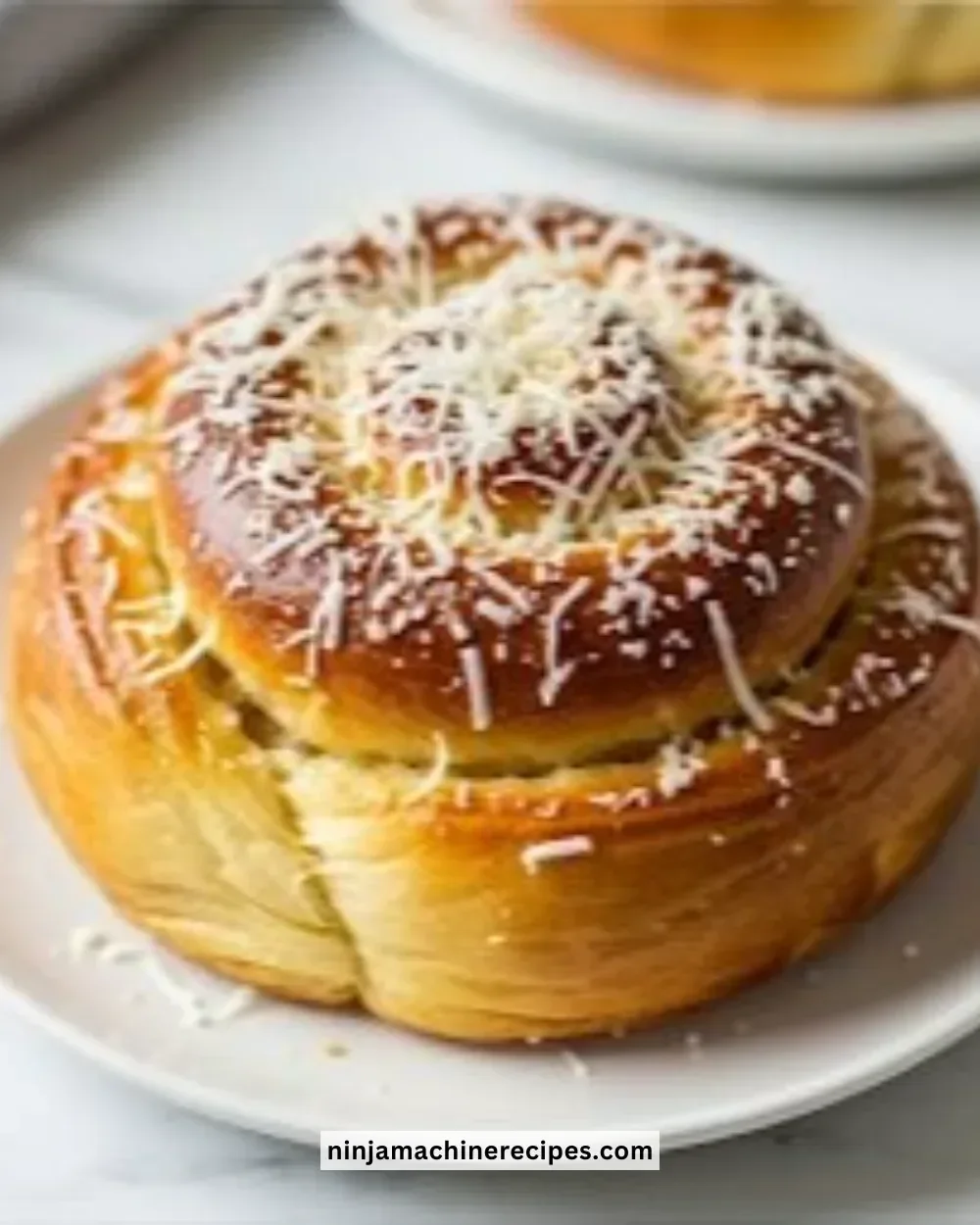 Classic Ensaymada Bread topped with cheese and butter, a traditional Filipino treat.
