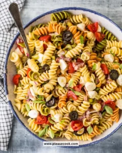 Bowl of classic pasta salad with vegetables and dressing