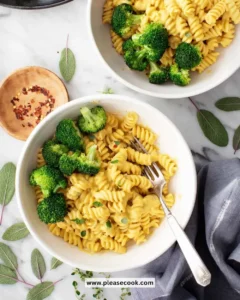 Creamy butternut squash pasta dish topped with herbs and cheese
