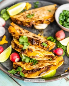 Crispy beef taquitos drizzled with chipotle sauce on a plate