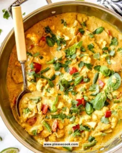 Serving of Curry Chicken with Apple on a plate garnished with herbs