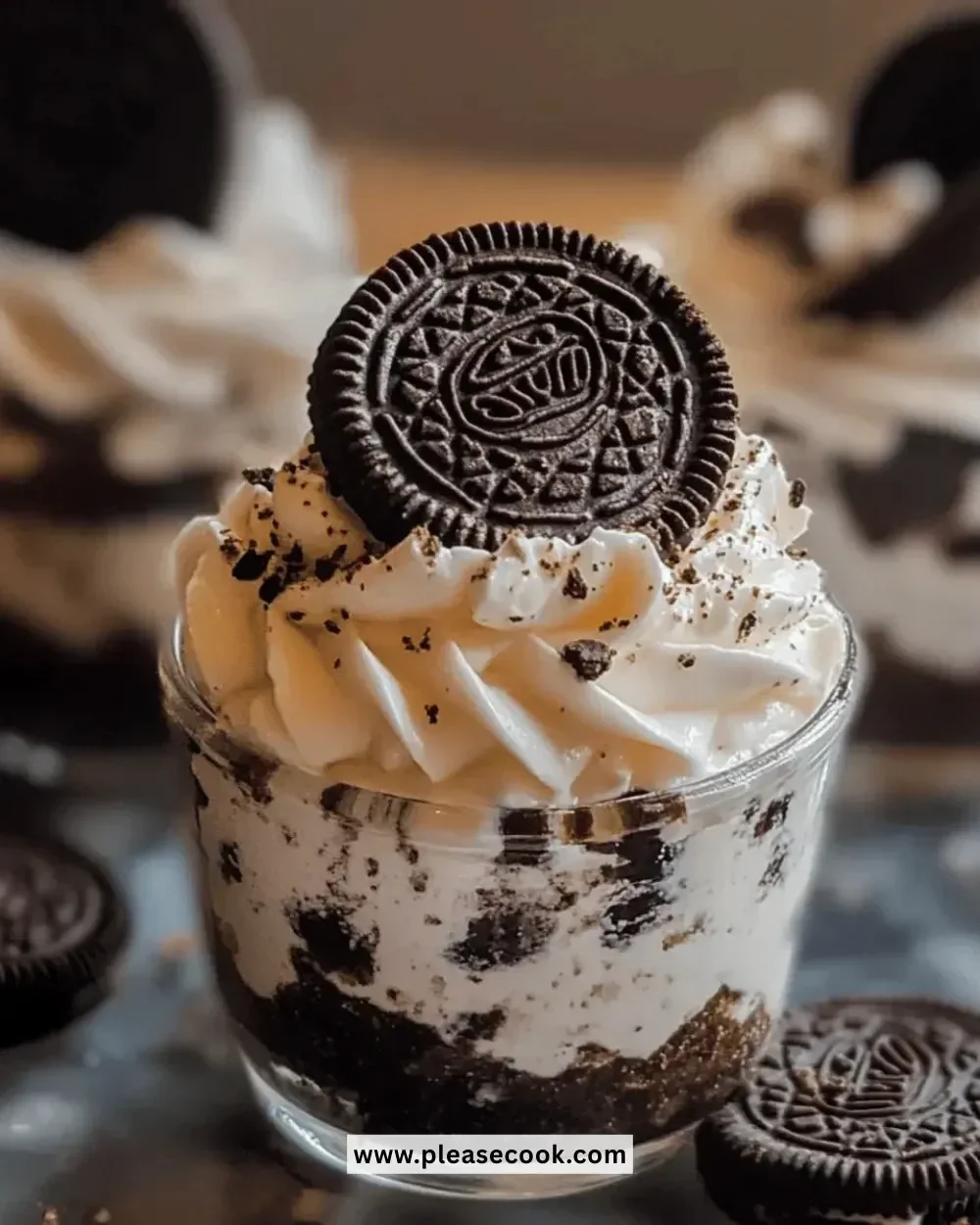 Easy no-bake Oreo cheesecake cups garnished with crushed Oreos and whipped cream