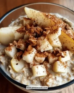 Bowl of easy pear cinnamon overnight oats topped with slices of pear and cinnamon.