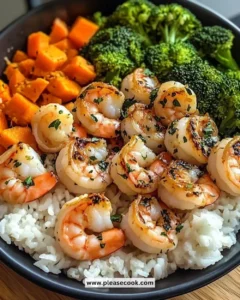 Delicious garlic butter shrimp with steamed rice and mixed vegetables on a plate.