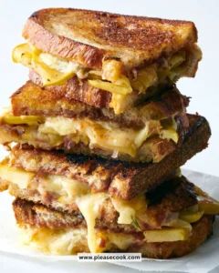 Grilled cheese sandwich with apple slices and apple butter on a plate