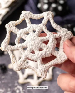 Halloween Cobweb Cookies decorated with spooky icing and Halloween-themed designs