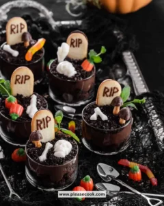 Delicious Halloween Dirt Pudding Cups topped with gummy worms and crushed cookies.