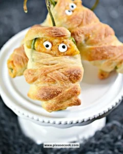 Spooky Halloween jalapeno poppers with cheese and toppings