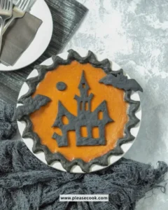 Delicious Halloween Pumpkin Pie garnished with whipped cream and spices