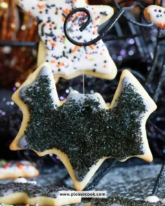 Colorful Halloween sugar cookies shaped like ghosts, pumpkins, and bats.