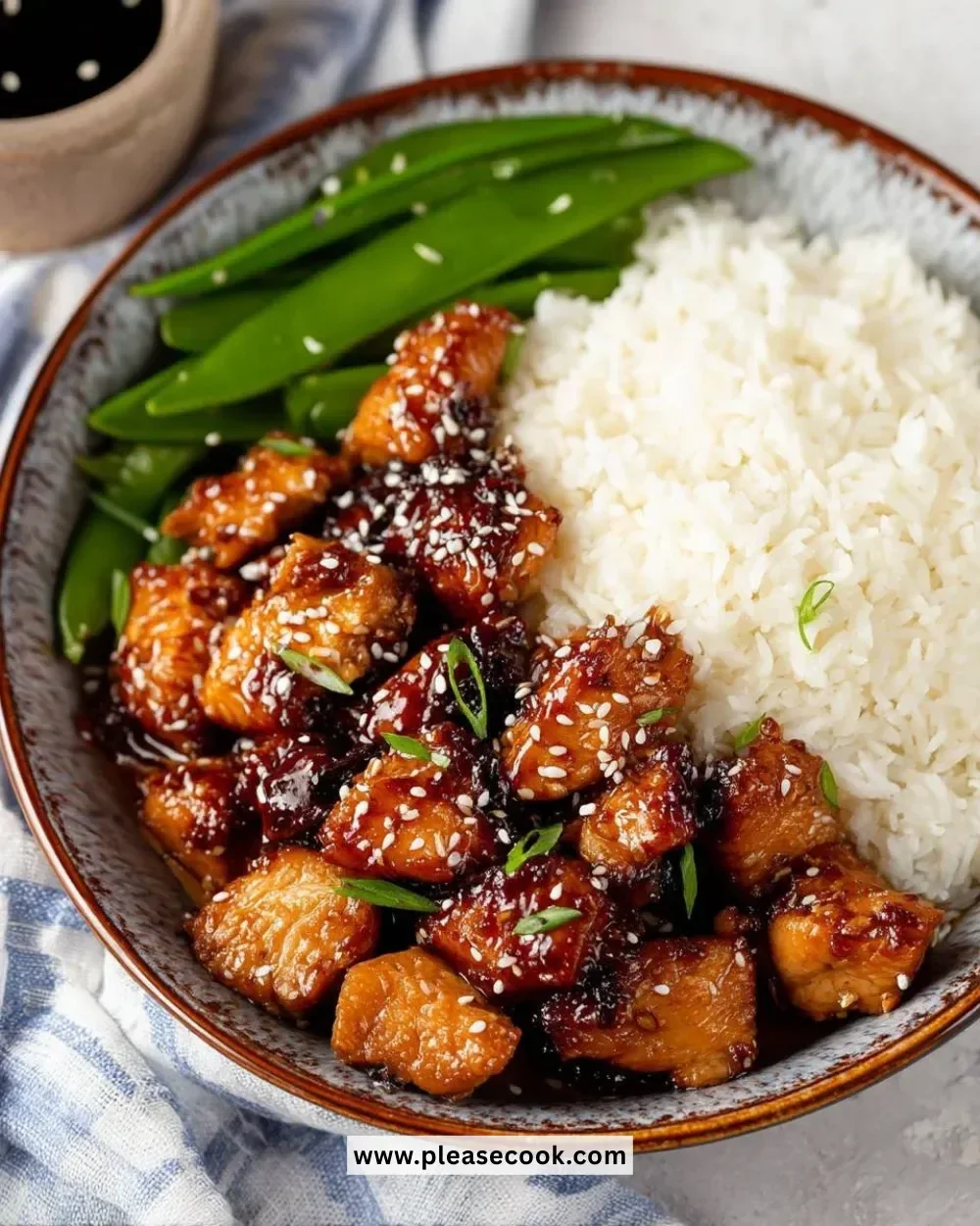 Healthy sesame chicken dish with colorful vegetables and sesame seeds