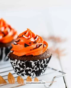 Delicious orange and black cupcakes topped with festive decorations