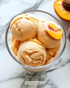 Delicious bowl of Peach Greek Frozen Yogurt topped with fresh peaches and mint