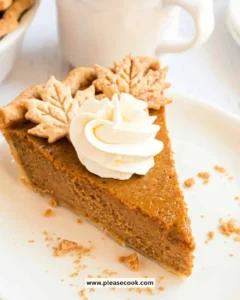Delicious homemade pumpkin pie with whipped cream topping on a rustic table