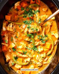 Bowl of Slow Cooker Thai Coconut Chicken garnished with fresh herbs