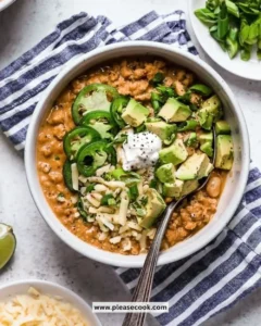 Bowl of Slow Cooker Turkey and White Bean Chili garnished with herbs