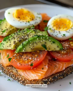Delicious smoked salmon avocado toast topped with fresh ingredients on a plate.