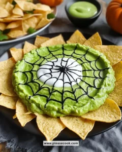 Spiderweb Guacamole served in a bowl with decorative topping