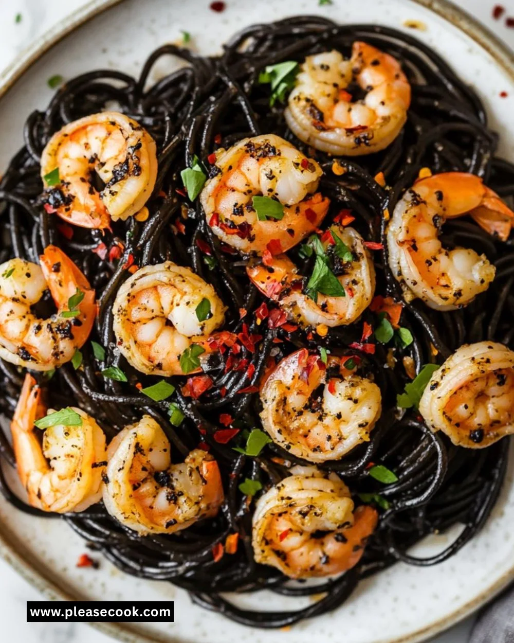 Plate of Vampire Pasta with garlic and shrimp, garnished with herbs