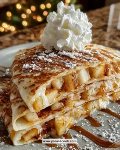 Apple cinnamon breakfast quesadillas on a plate, drizzled with syrup.