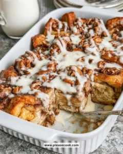 Cinnamon Roll French Toast Casserole served in a baking dish with cinnamon and icing