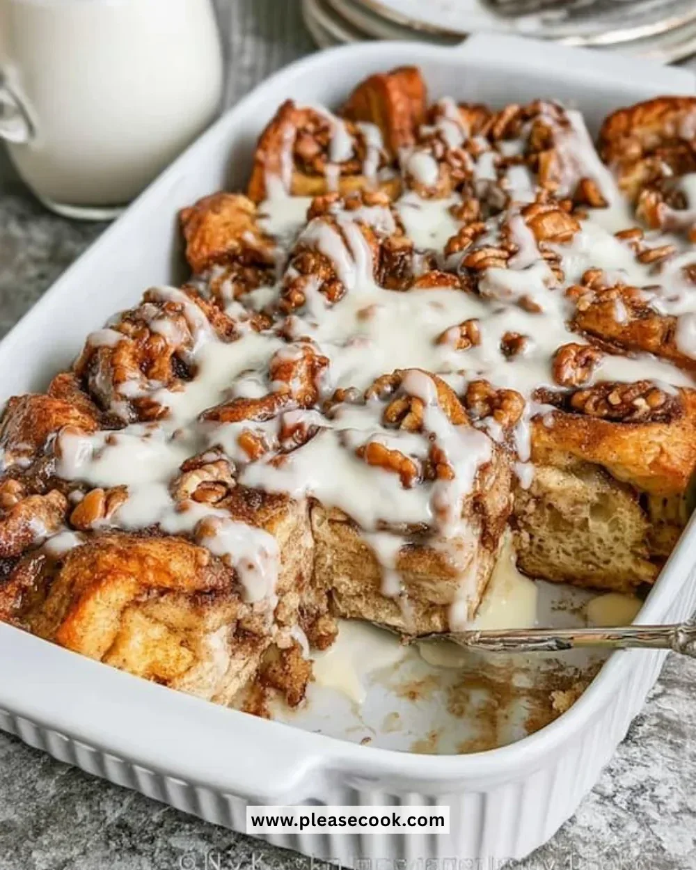 Cinnamon Roll French Toast Casserole served in a baking dish with cinnamon and icing