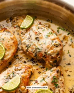 Creamy cilantro lime chicken garnished with fresh cilantro and lime slices.
