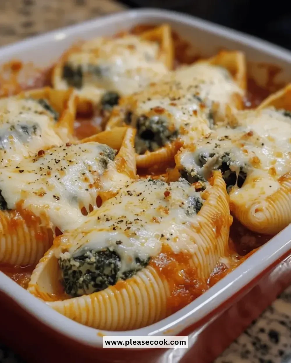 Easy cheesy spinach stuffed shells on a plate garnished with parsley.