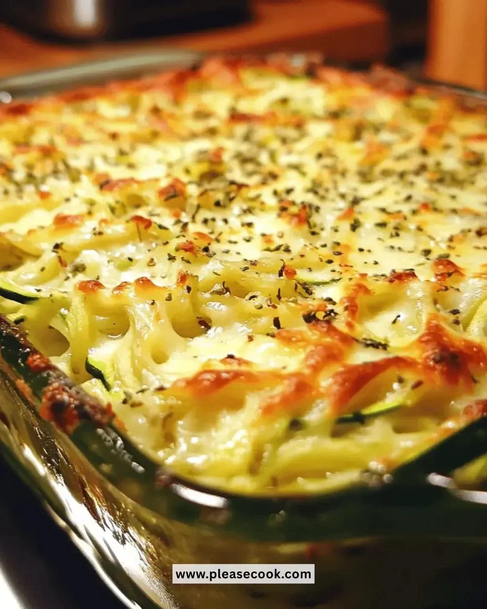 Easy Cheesy Zucchini Noodle Bake topped with melted cheese and herbs