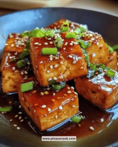 Delicious honey soy glazed tofu served on a plate with vegetables