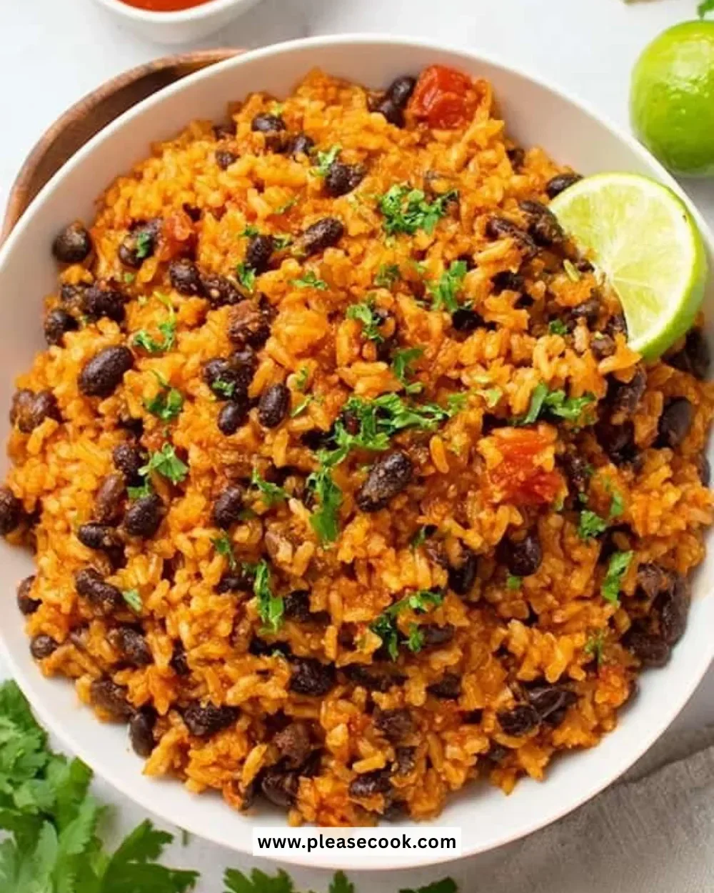 A bowl of easy rice and beans topped with fresh herbs.