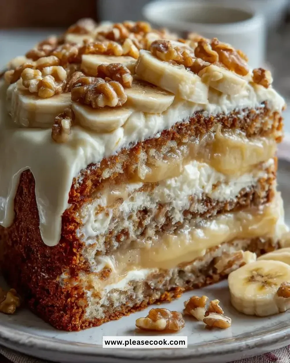 Heavenly Banana Walnut Cream Cake topped with creamy frosting and walnuts.