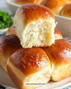 Homemade dinner rolls fresh out of the oven, golden and fluffy.