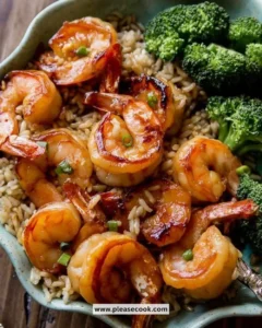 Plate of Honey Garlic Shrimp garnished with green onions and sesame seeds