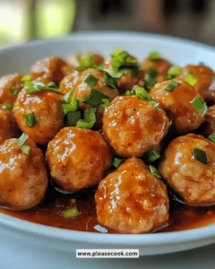 Juicy sweet chili chicken meatballs served on a plate with dipping sauce