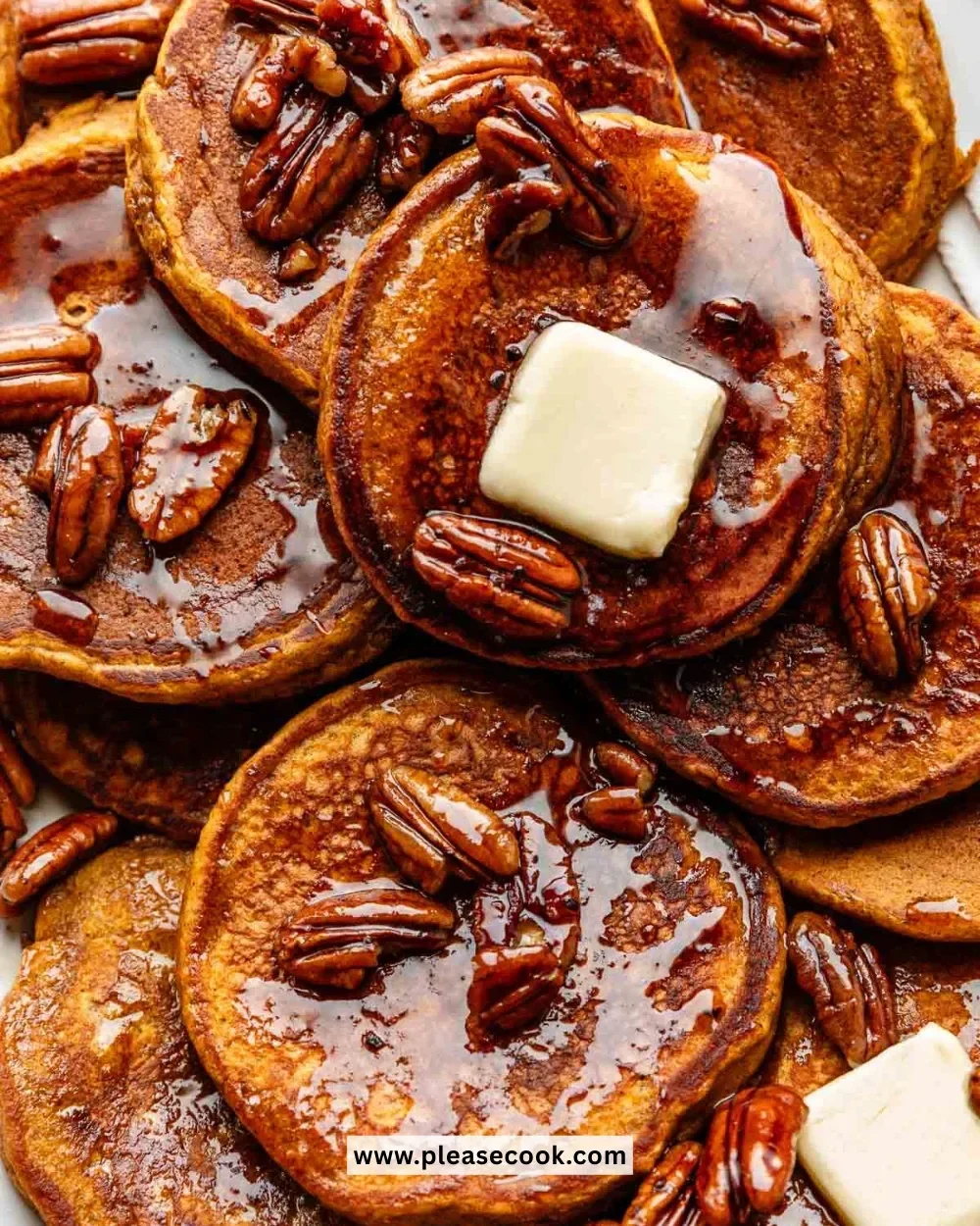Delicious pumpkin pancakes served on a plate with whipped cream and syrup