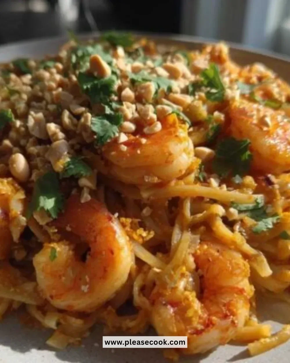 A colorful plate of 15-Minute Pad Thai garnished with lime and peanuts.
