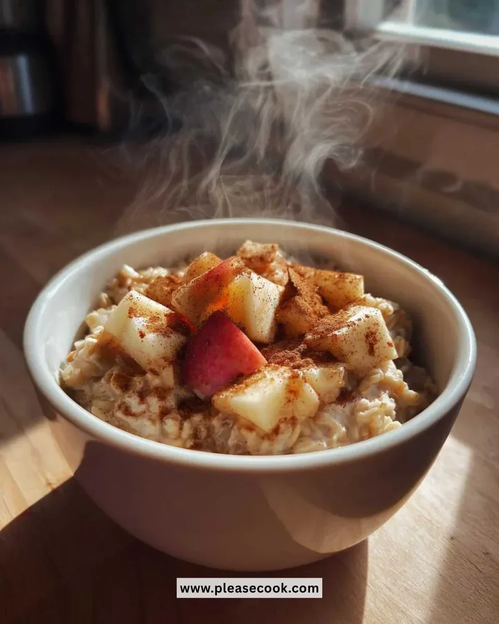 Bowl of 5-minute apple pie oatmeal topped with apple slices and cinnamon.