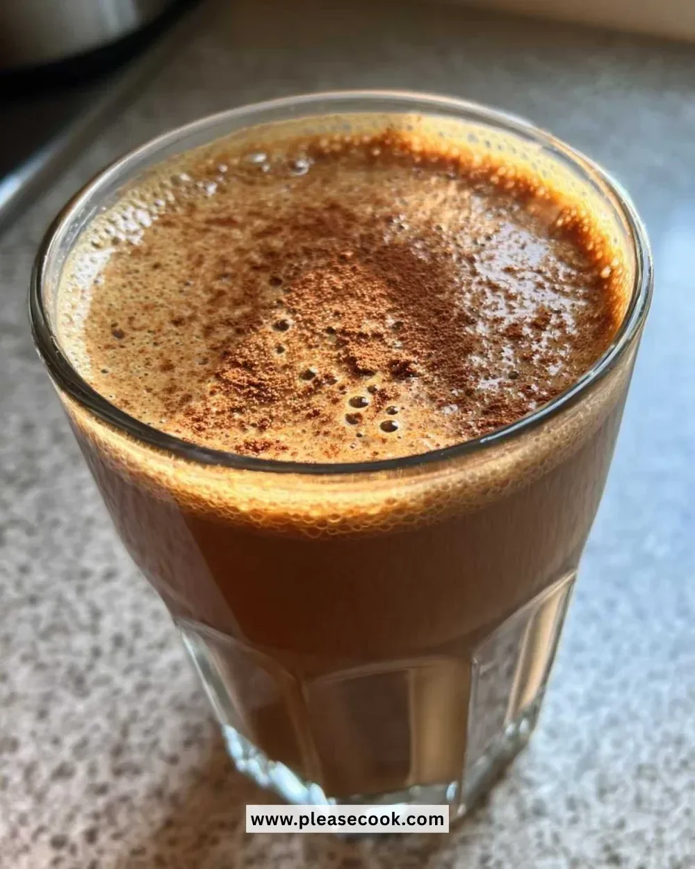 A festive gingerbread smoothie topped with whipped cream and spices