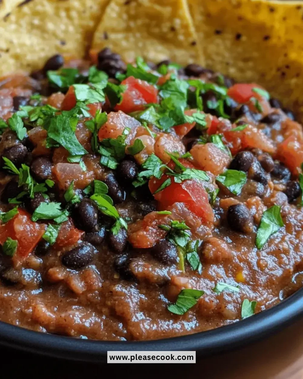 Bowl of best spicy black bean dip with tortilla chips