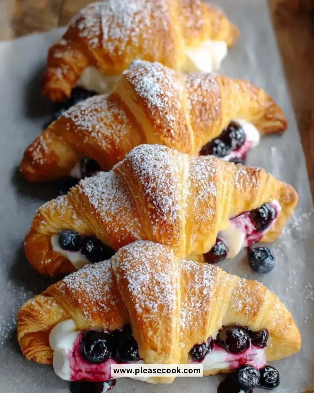 Blueberry cheesecake crescent rolls topped with fresh blueberries