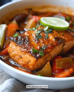 Delicious Caribbean Brown Stew Salmon served on a plate with herbs and vegetables